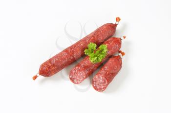 fresh salami sausages on white background