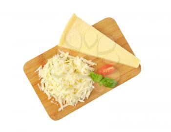 grated parmesan cheese on wooden cutting board