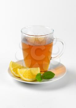 hot tea in glass cup and fresh lemon slices