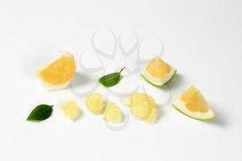 slices of green grapefruit on white background