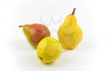ripe pears and apple on white background