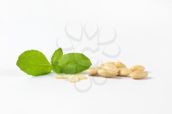 handful of skinless almonds on white background