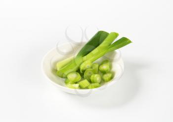 chopped green onion in white bowl