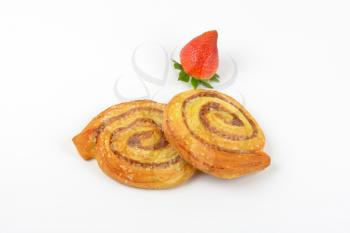 sweet cinnamon rolls and strawberry on white background