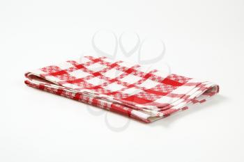 red and white checkered dish towel on white background