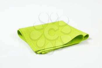 folded green cloth place mat