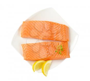 two fresh salmon fillets on plate