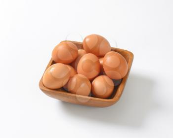 bowl of fresh eggs on white background