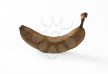brown overripe banana on white background