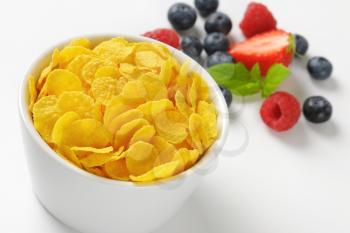 bowl of corn flakes and berry fruits - close up