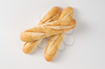 three French baguettes on white background