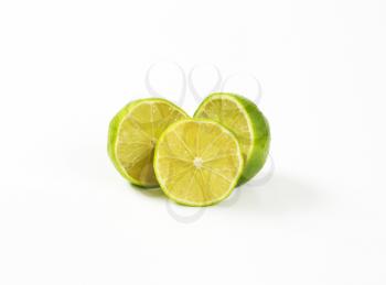 halved fresh lime on white background