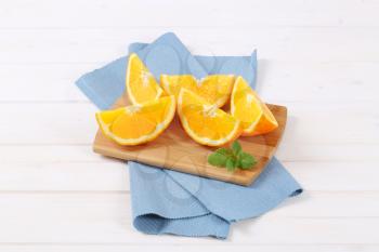 slices of fresh orange on wooden cutting board