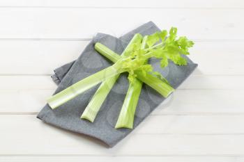 stems of green celery on grey place mat