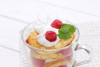 cup of american pancakes with white yogurt and fresh raspberries - close up