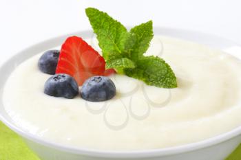 bowl of semolina pudding with fresh fruit - detail