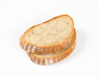 Two thick slices of moist continental bread on white background