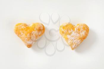 two heart shaped cookies on white background