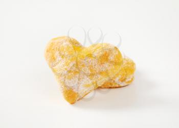 two heart shaped cookies on white background