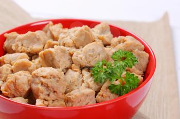 bowl of soy meat cubes on beige place mat - close up
