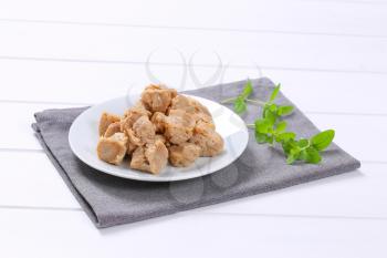 plate of soy meat cubes on grey place mat