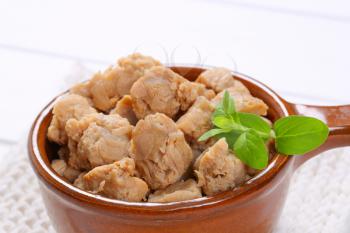 saucepan of soy meat cubes on white table mat - close up