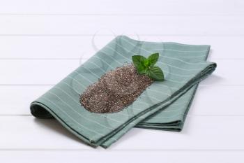pile of chia seeds on grey place mat