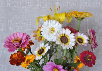 A bouquet of garden flowers on the background of an old linen canvas. August, the Central Russia