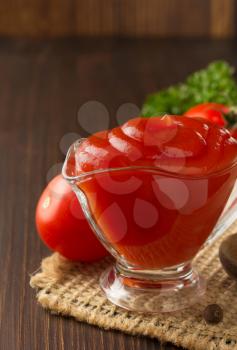 tomato sauce on wooden background