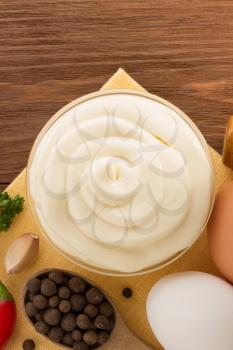 mayonnaise sauce in bowl on wooden background