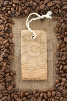 coffee beans and tag price label on wood background texture