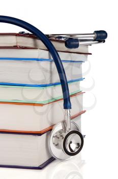 pile of books and stethoscope isolated on white background