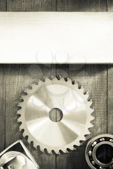 circular saw blade on wooden background texture