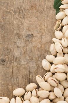 pistachios nuts on wood background
