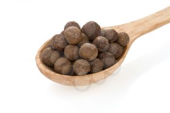 allspice spices in spoon isolated on white background