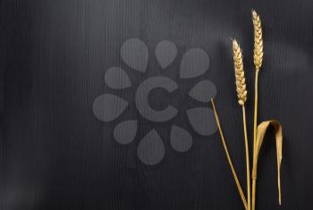 ears of wheat on wooden background