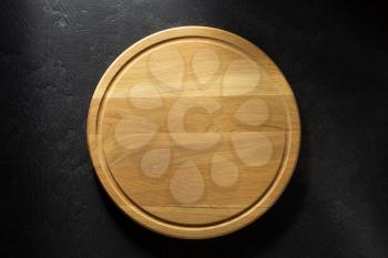 pizza cutting board at black background