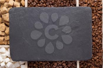 coffee beans and slate stone black tray background, top view