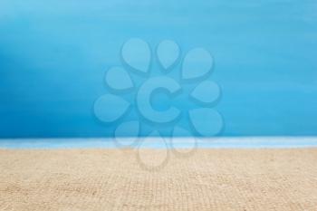burlap hessian sacking cloth on wooden background, table in front view