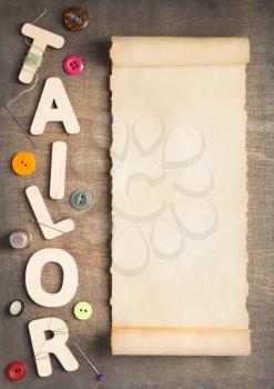 sewing tools and letters on wooden table background, top view