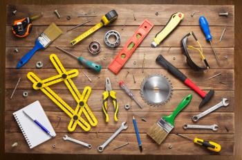 set of tools and instruments at wooden table surface background, top view
