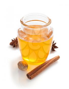 glass jar of honey isolated on white background