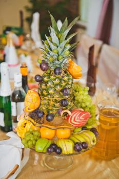Dish from Pineapple and fruit in the form of a vase.