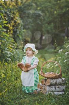 Little girl in vintage dress walking in the garden.