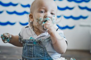 Portrait of a child covered in cake.