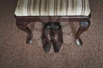 The chair laid on his suit and shoes.