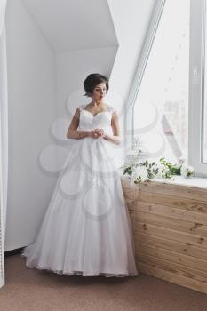 Portrait of a beautiful girl in a wedding dress in the Studio.