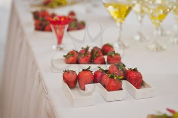Strawberries on a tray on the table.
