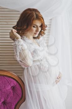 Redhead pregnant girl in a delicate situation.