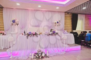 Richly decorated with flowers and fabrics hall for a wedding Banquet.